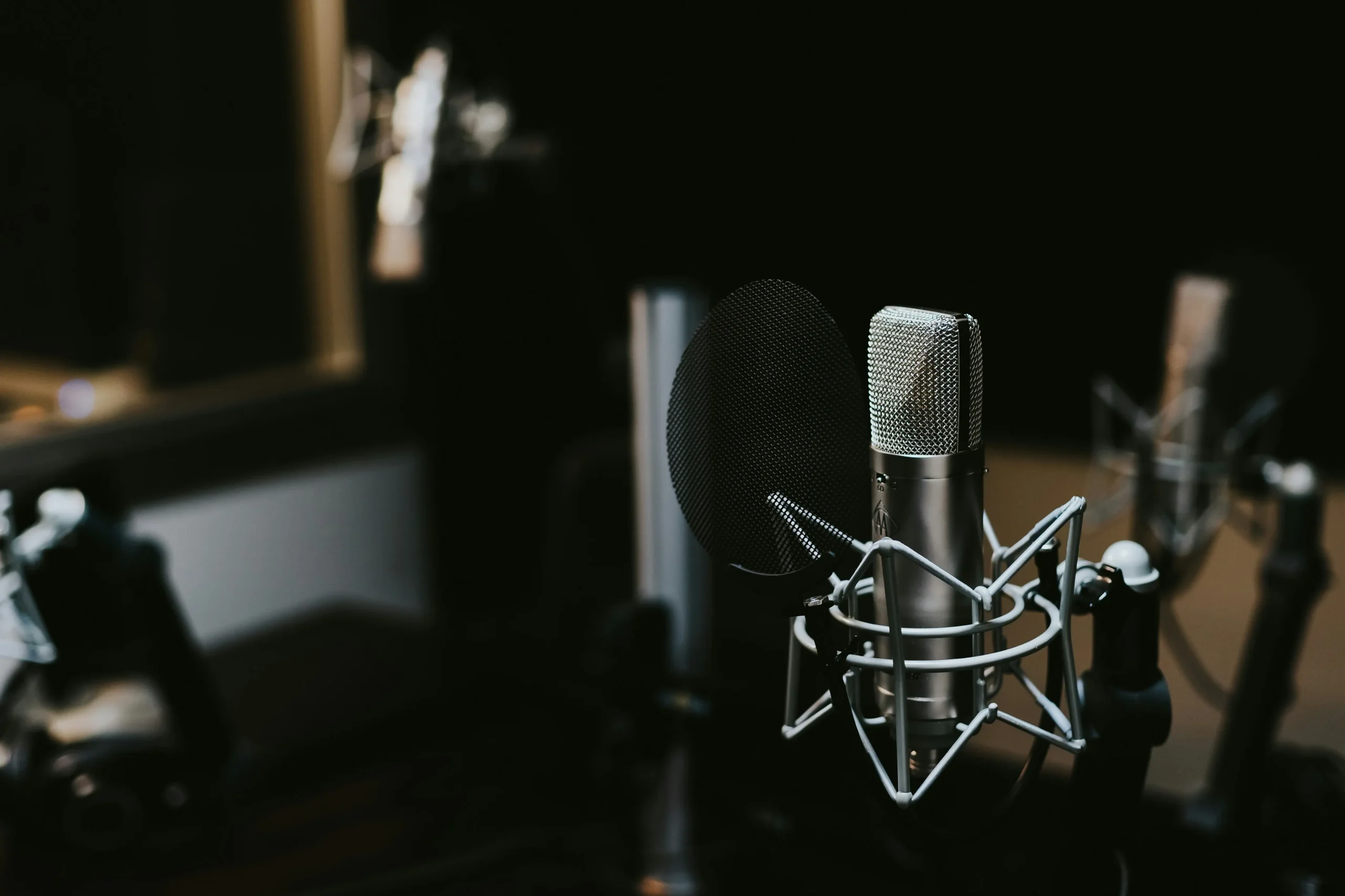 Professional condenser microphone in modern podcast studio setup